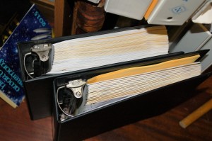 top view of notebooks for Drakemaster (epic fantasy) and thriller novel, about half as long. Both printed double-sided.